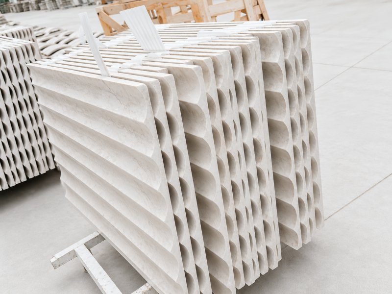 Fluted marble wall panels with repeated curved surface profiles Fluted marble wall panels with repeated curved surface profiles