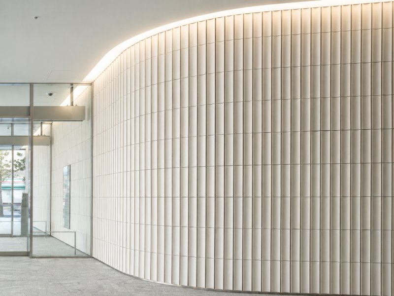 Installed fluted stone feature wall with vertical decorative profiles Installed fluted stone feature wall with vertical decorative profiles
