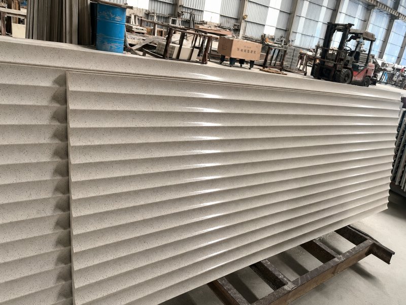 Finished wave-shaped stone panel with consistent grooves and smooth transitions Finished wave-shaped stone panel with consistent grooves and smooth transitions